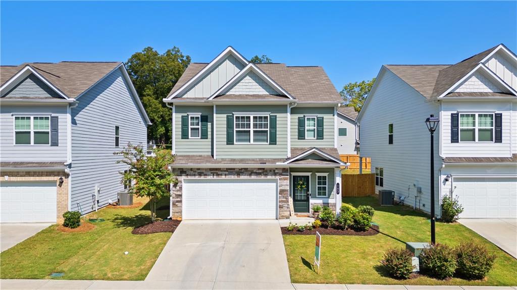 103 Waterside Drive Calhoun, GA 30701 - Photo 40 of 48 a front view of a house with a yard and garage