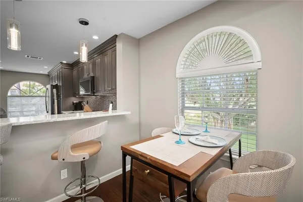 a view of a dining room with furniture window and outside view