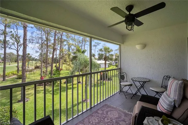 a view of a porch with furniture and a yard