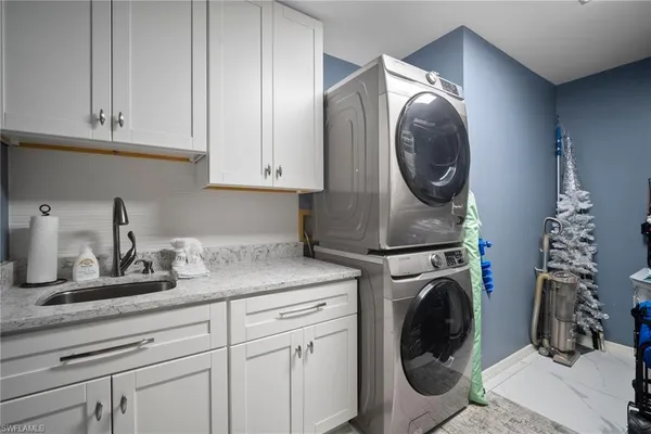 a kitchen with a sink and a washer dryer