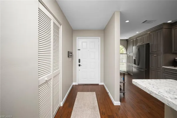 a view of a kitchen from a hallway