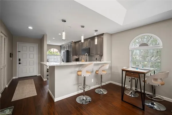 a view of workspace with wooden floor and windows