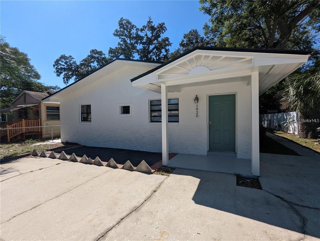 1922 Springtime Avenue Clearwater, FL 33755 - Photo 1 of 27 a front view of a house with a yard
