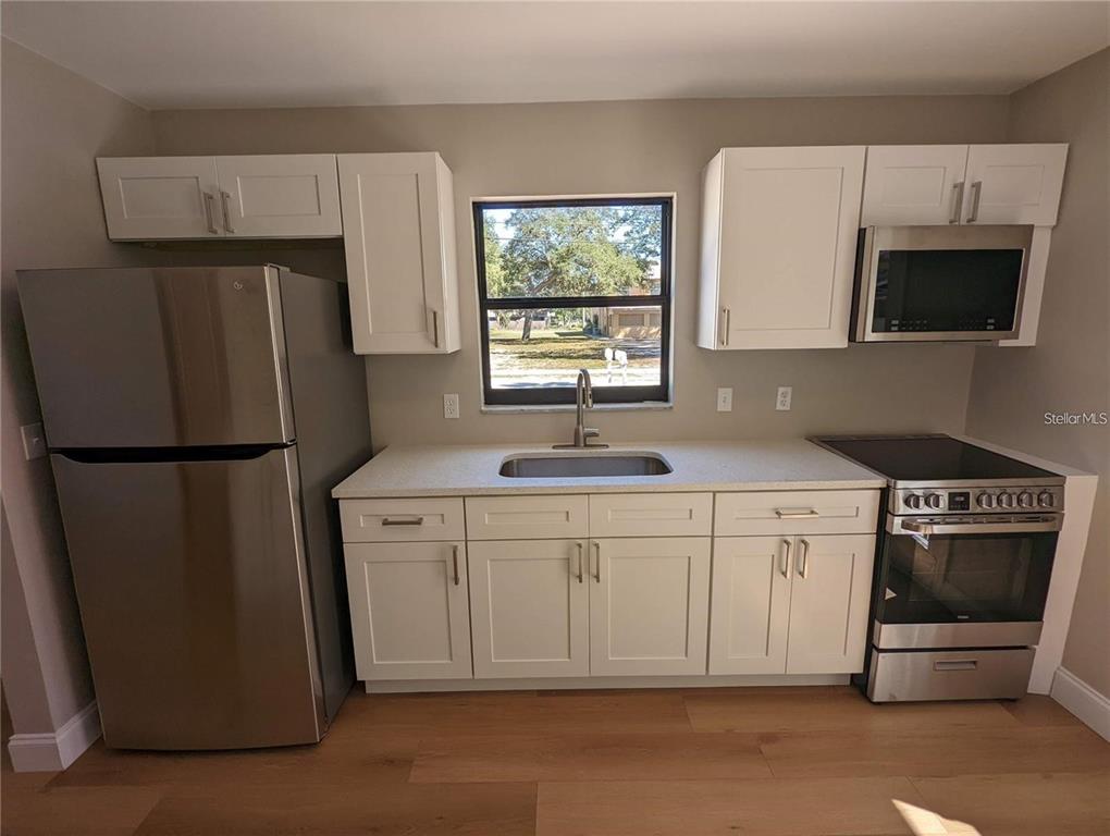 1922 Springtime Avenue Clearwater, FL 33755 - Photo 11 of 27 a kitchen with stainless steel appliances a refrigerator sink and microwave