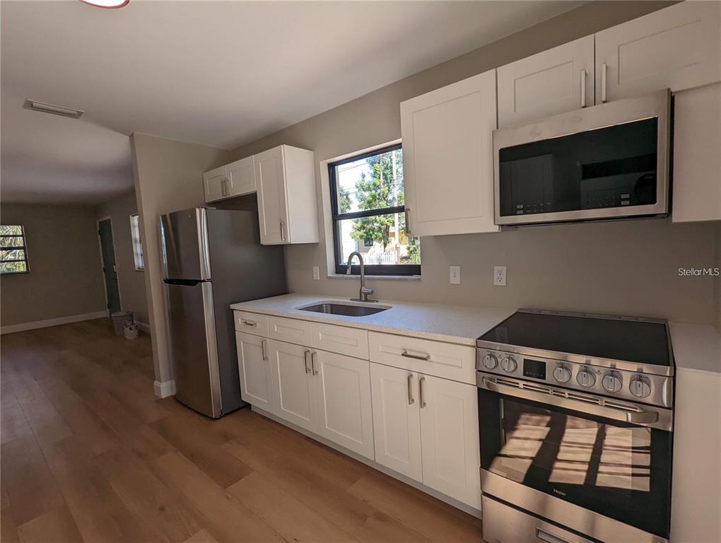 1922 Springtime Avenue Clearwater, FL 33755 - Photo 12 of 27 a kitchen with stainless steel appliances a microwave a sink and a refrigerator