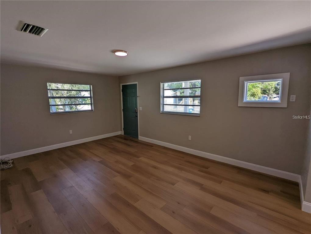 1922 Springtime Avenue Clearwater, FL 33755 - Photo 4 of 27 a view of an empty room with wooden floor and a window