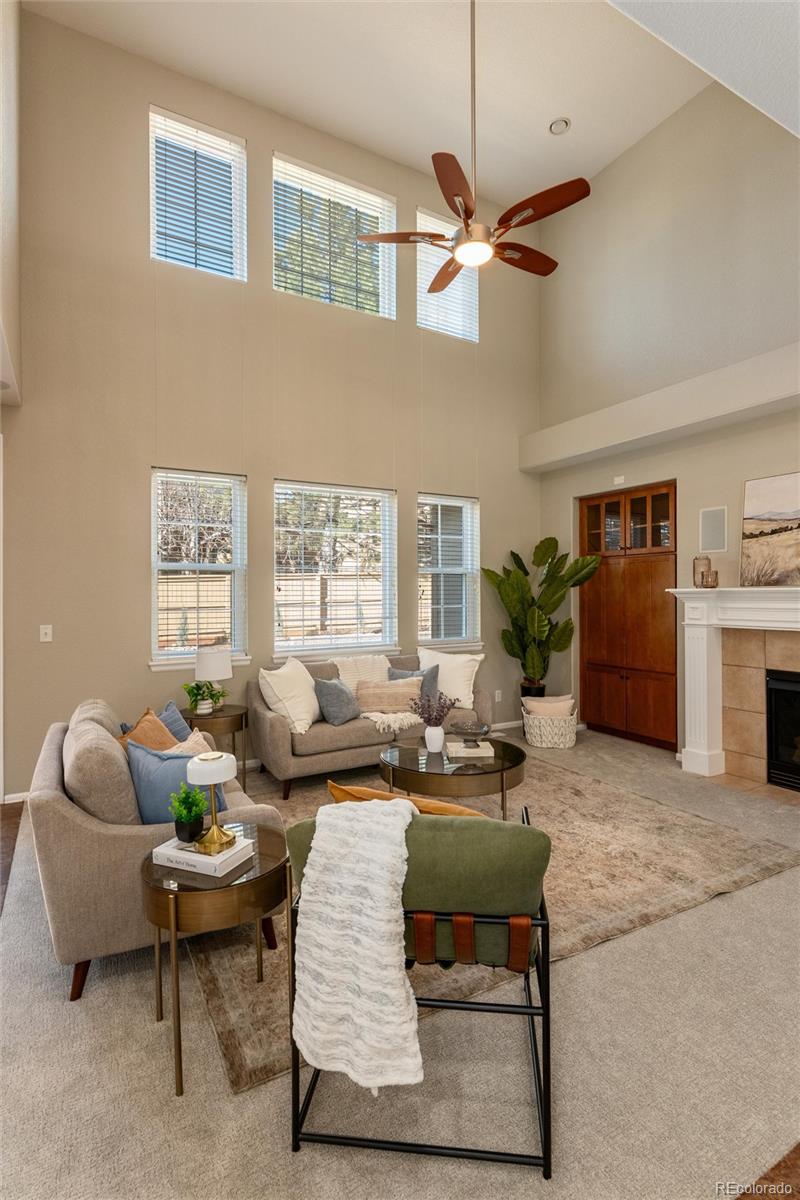 10820 Montvale Circle Highlands Ranch, CO 80130 - Photo 15 of 50 a living room with furniture ceiling fan and a rug