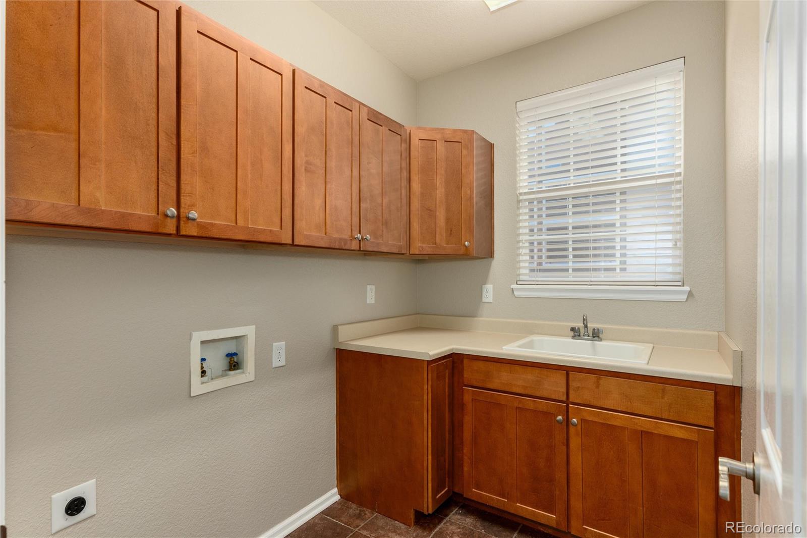 10820 Montvale Circle Highlands Ranch, CO 80130 - Photo 17 of 50 a kitchen with stainless steel appliances granite countertop wooden cabinets a sink and a window
