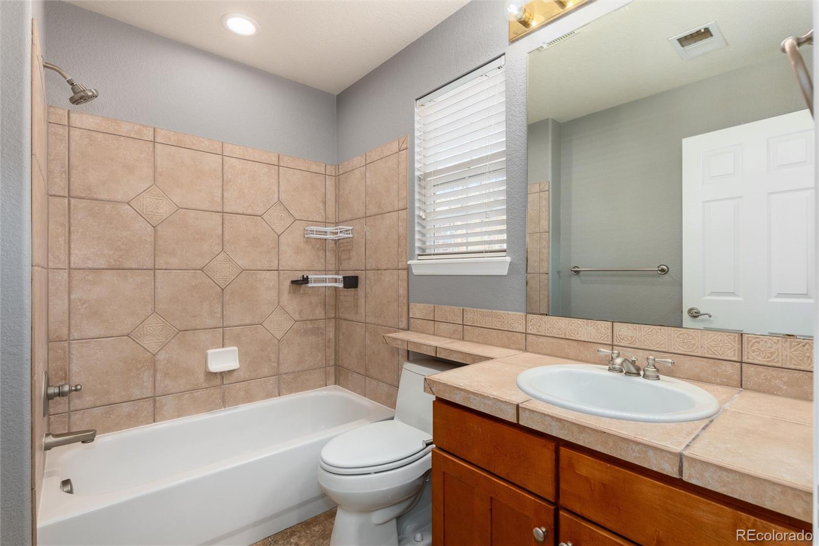 10820 Montvale Circle Highlands Ranch, CO 80130 - Photo 29 of 50 a bathroom with a sink a toilet and bathtub