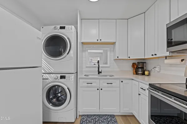 a view of a kitchen with washer and dryer