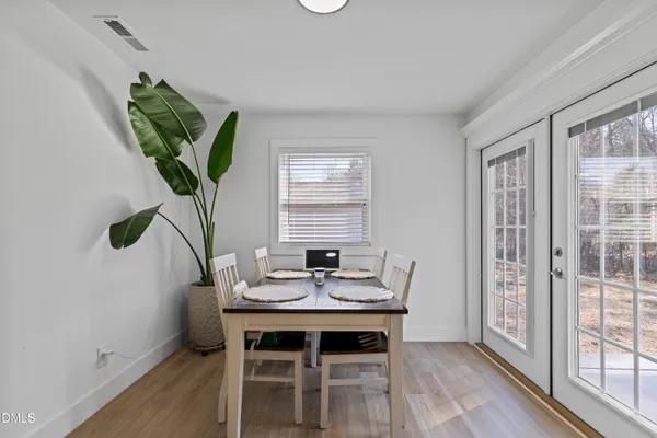 a view of a dining room with furniture window and wooden floor