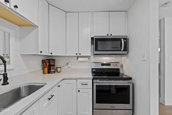 a stove top oven sitting inside of a kitchen
