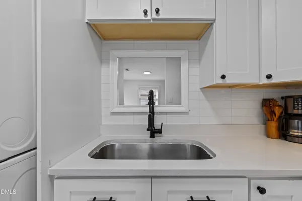 a kitchen with a sink and a stove