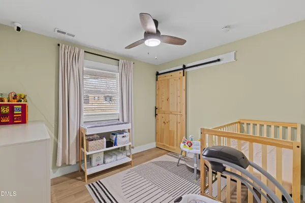 a bedroom with furniture and wooden floor
