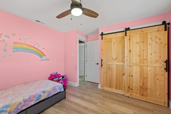 a bedroom with a bed and a chandelier