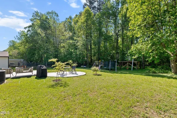 a view of a backyard with sitting area
