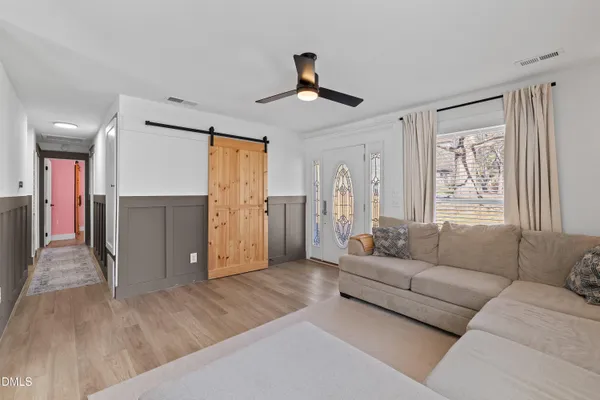 a living room with furniture and a chandelier