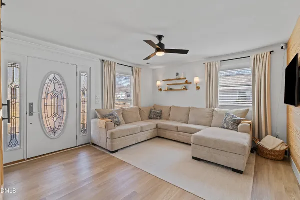 a living room with furniture and a chandelier