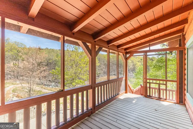 a view of a porch with wooden floor in front of a house