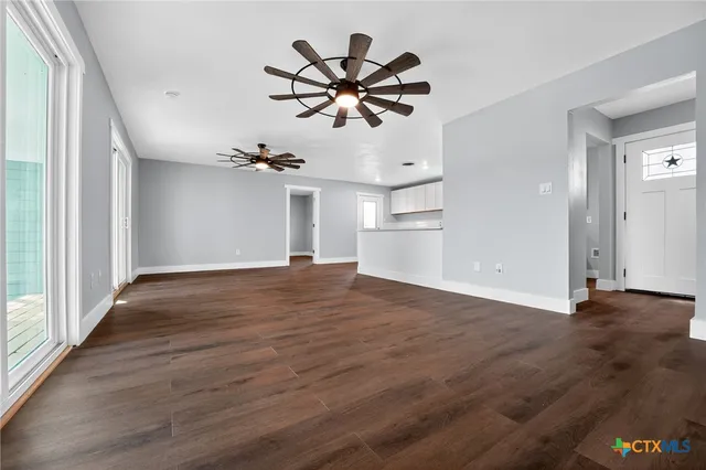 wooden floor in an empty room with a window