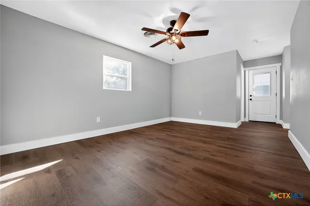 a view of a big room with wooden floor closet and windows