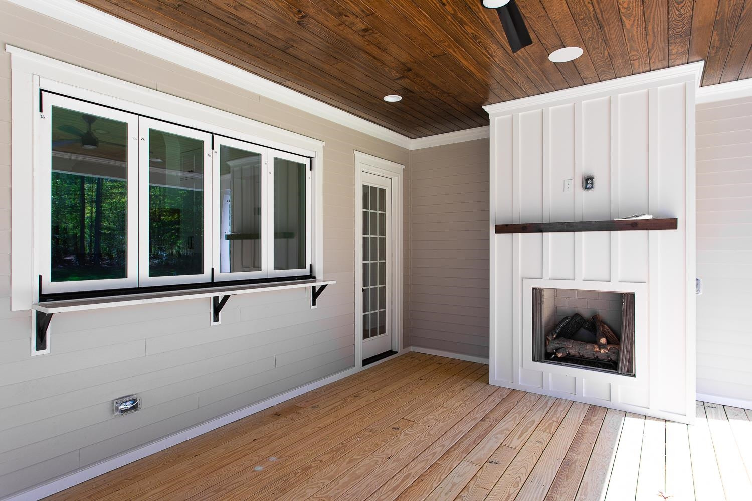 1417 Starry Night Court Raleigh, NC 27613 - Photo 41 of 44 a view of an empty room with wooden floor fireplace and a window
