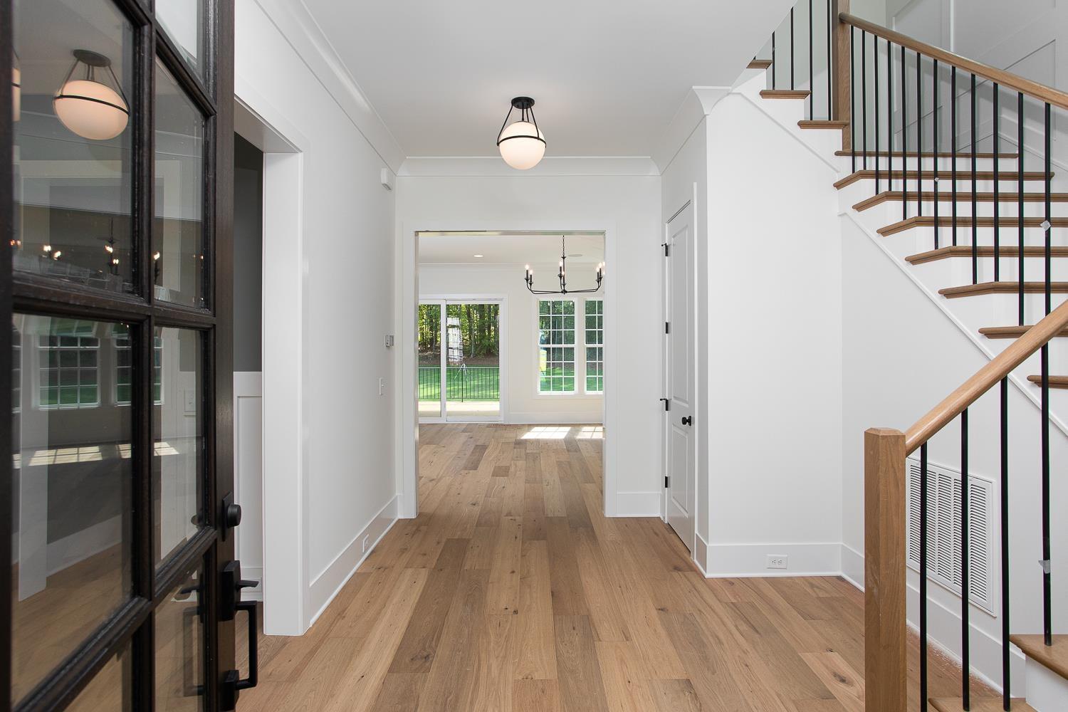 1417 Starry Night Court Raleigh, NC 27613 - Photo 6 of 44 a view of a hallway with wooden floor and staircase
