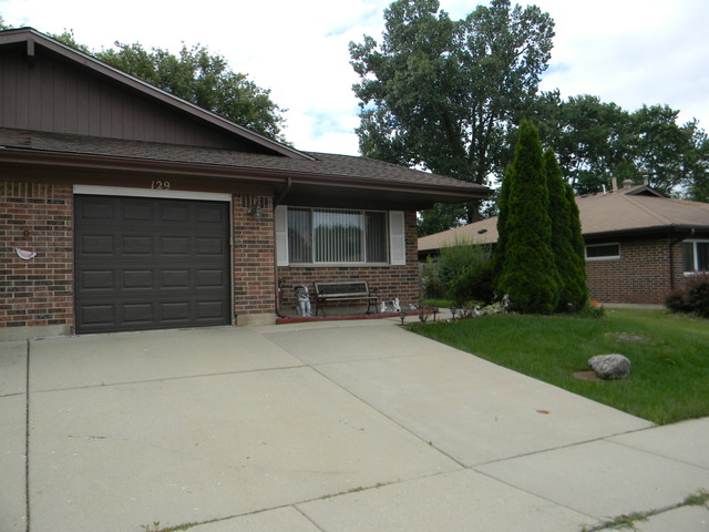 129 Virginia Court Streamwood, IL 60107 - Photo 1 of 14 a front view of a house with a yard