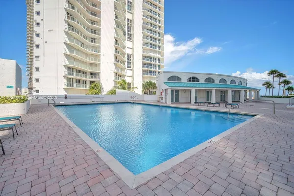 a view of pool with outdoor seating
