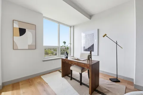 a workspace with wooden floor and windows
