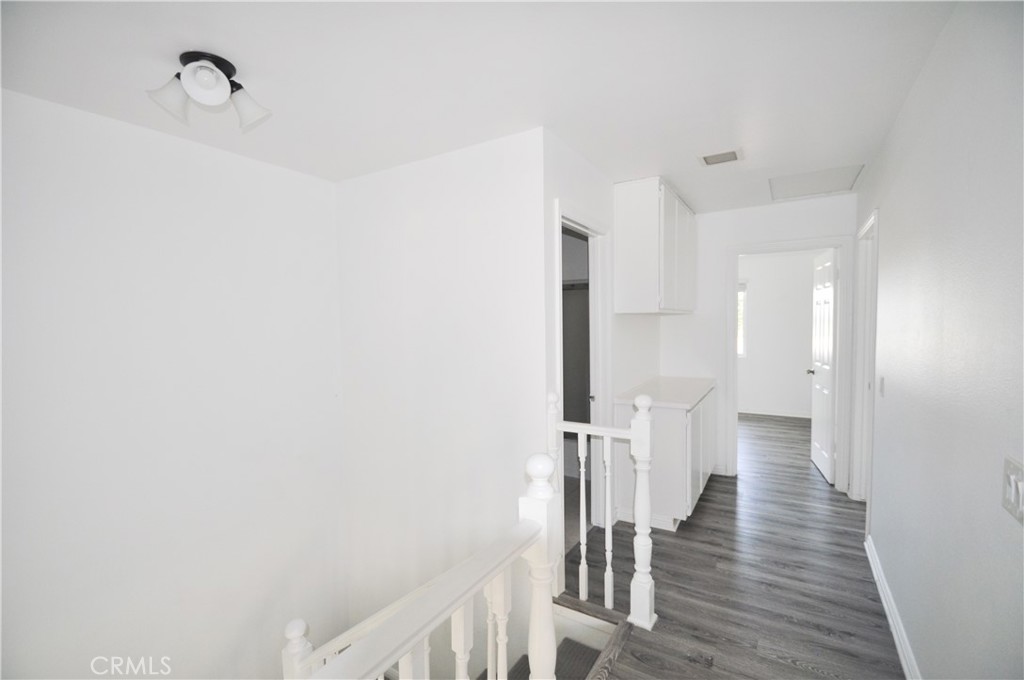 6 Pendelton Irvine, CA 92620 - Photo 11 of 18 a view of a hallway with wooden floor and staircase
