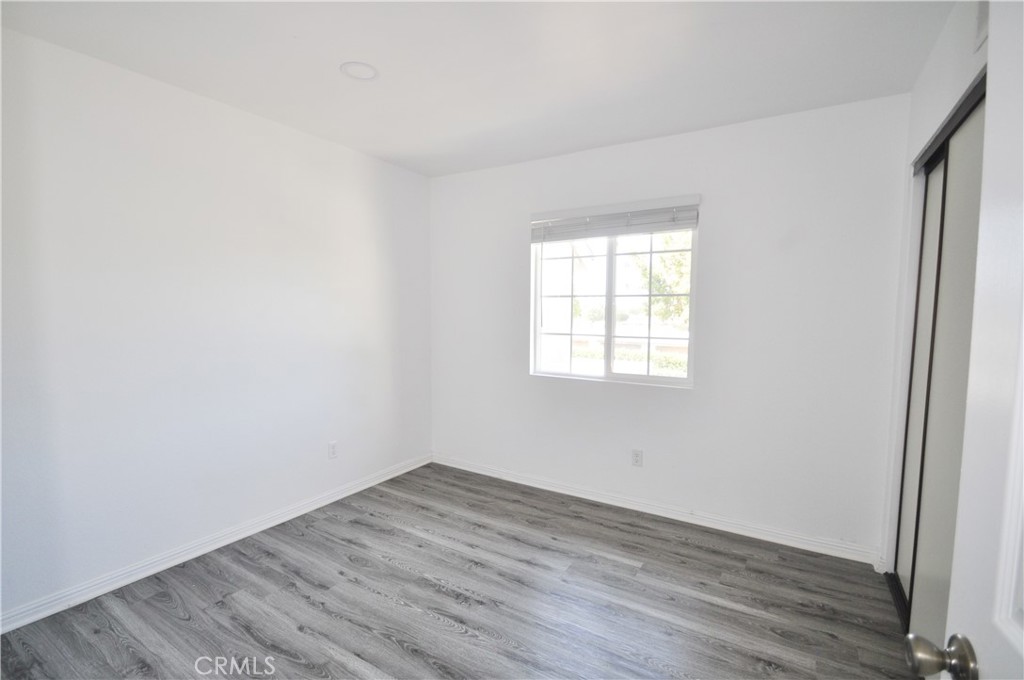 6 Pendelton Irvine, CA 92620 - Photo 13 of 18 an empty room with wooden floor and windows