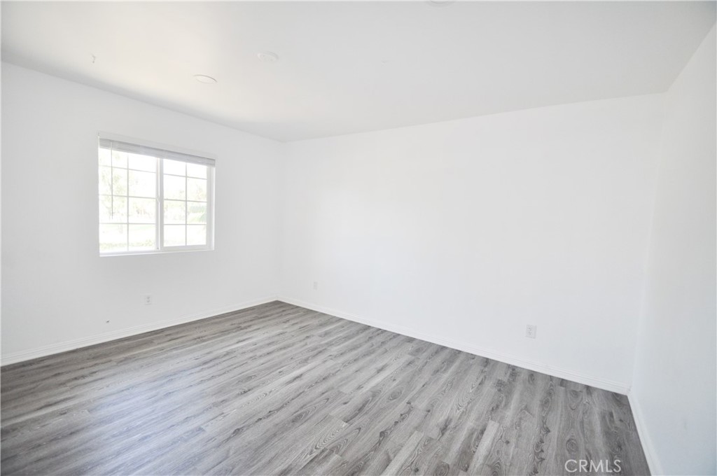 6 Pendelton Irvine, CA 92620 - Photo 15 of 18 an empty room with wooden floor and windows