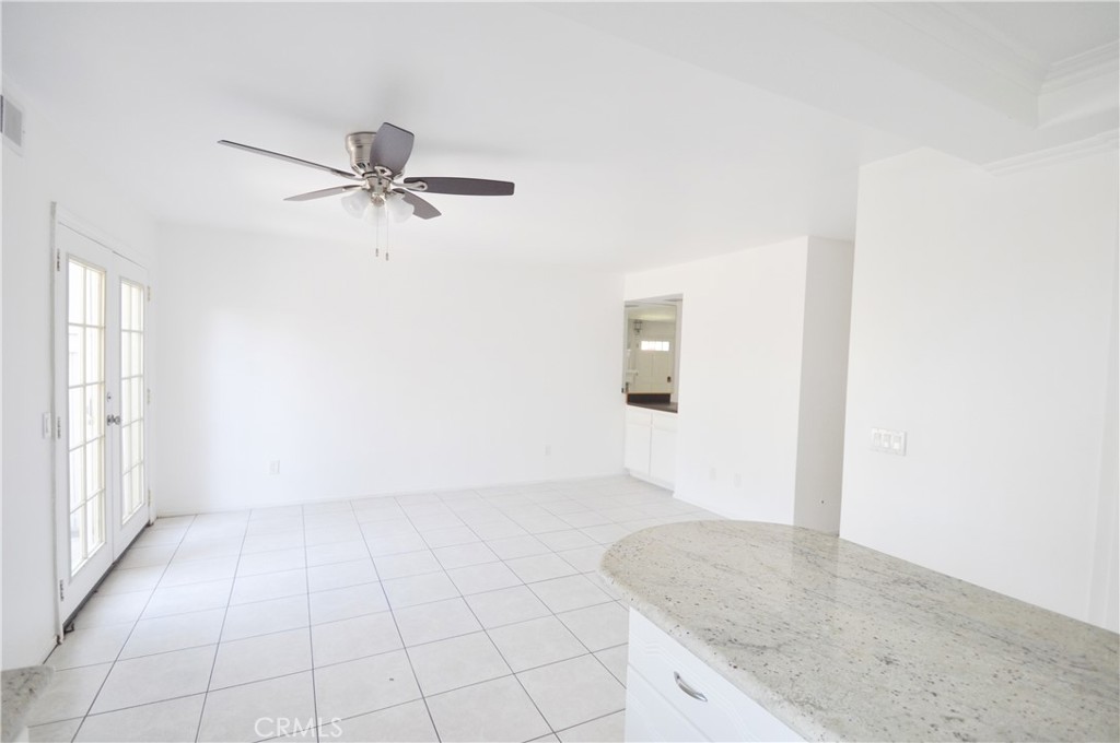 6 Pendelton Irvine, CA 92620 - Photo 8 of 18 an empty room with a empty space and kitchen view