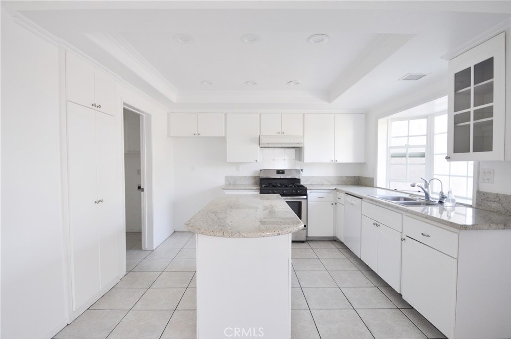 6 Pendelton Irvine, CA 92620 - Photo 10 of 18 a kitchen with white cabinets a sink and appliances