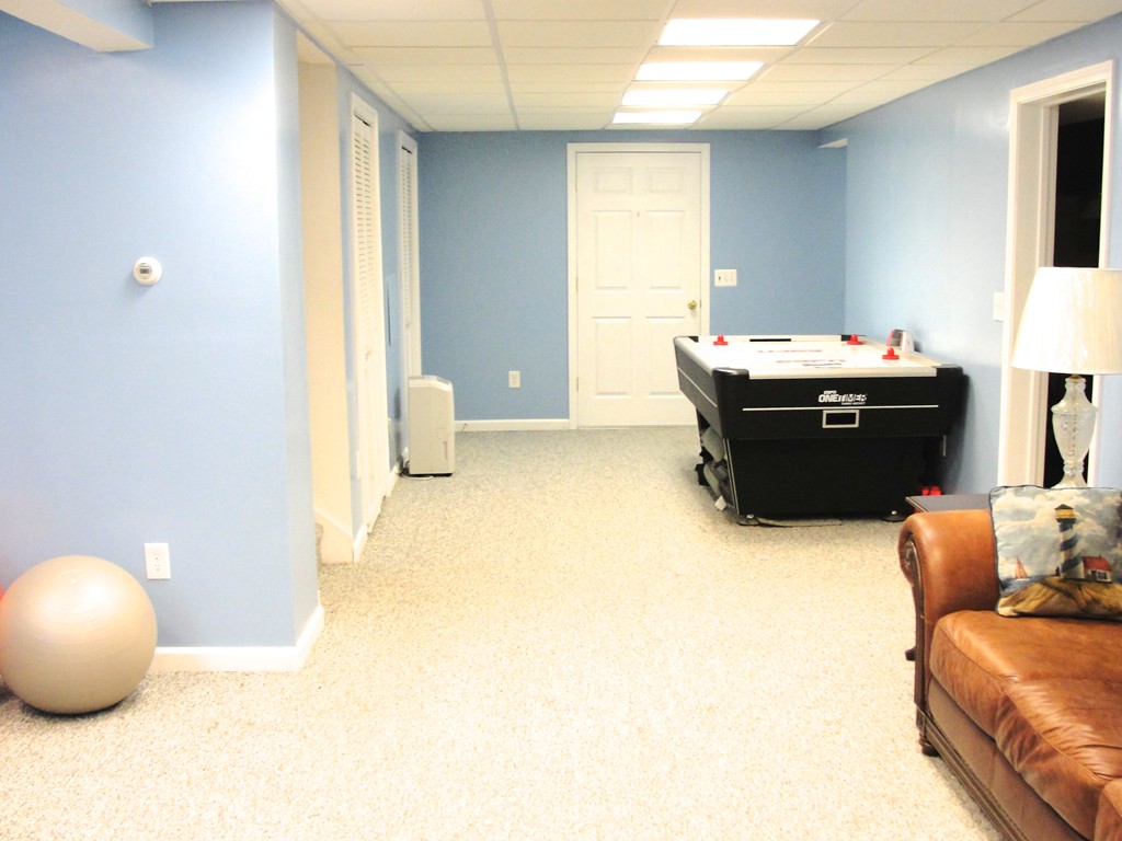 79 Valley Road Southampton, MA 01073 - Photo 22 of 30 a living room with a couch and a flat screen tv
