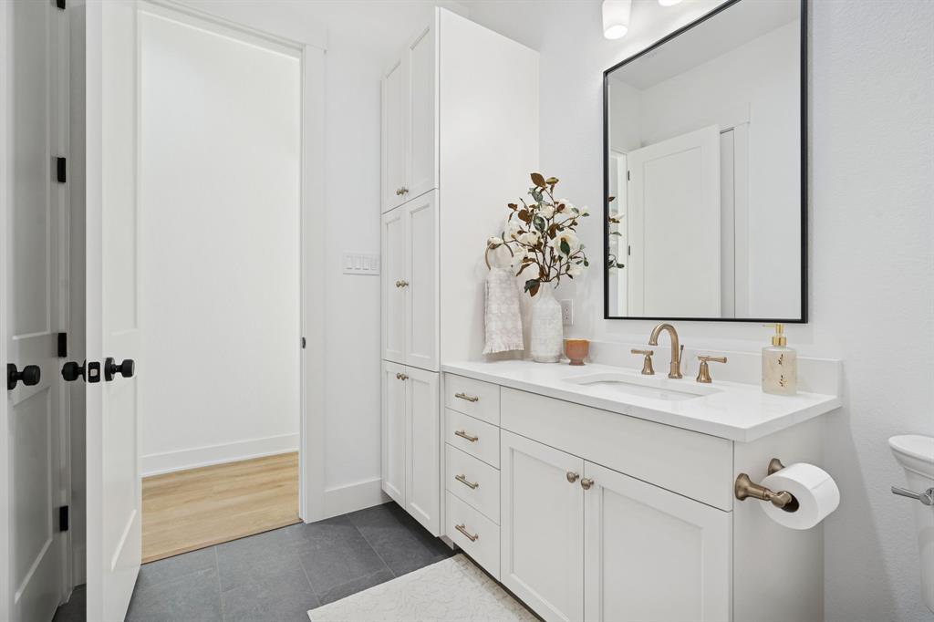 8008 Ben Day Murrin Road Fort Worth, TX 76126 - Photo 26 of 40 a bathroom with a double vanity sink and mirror