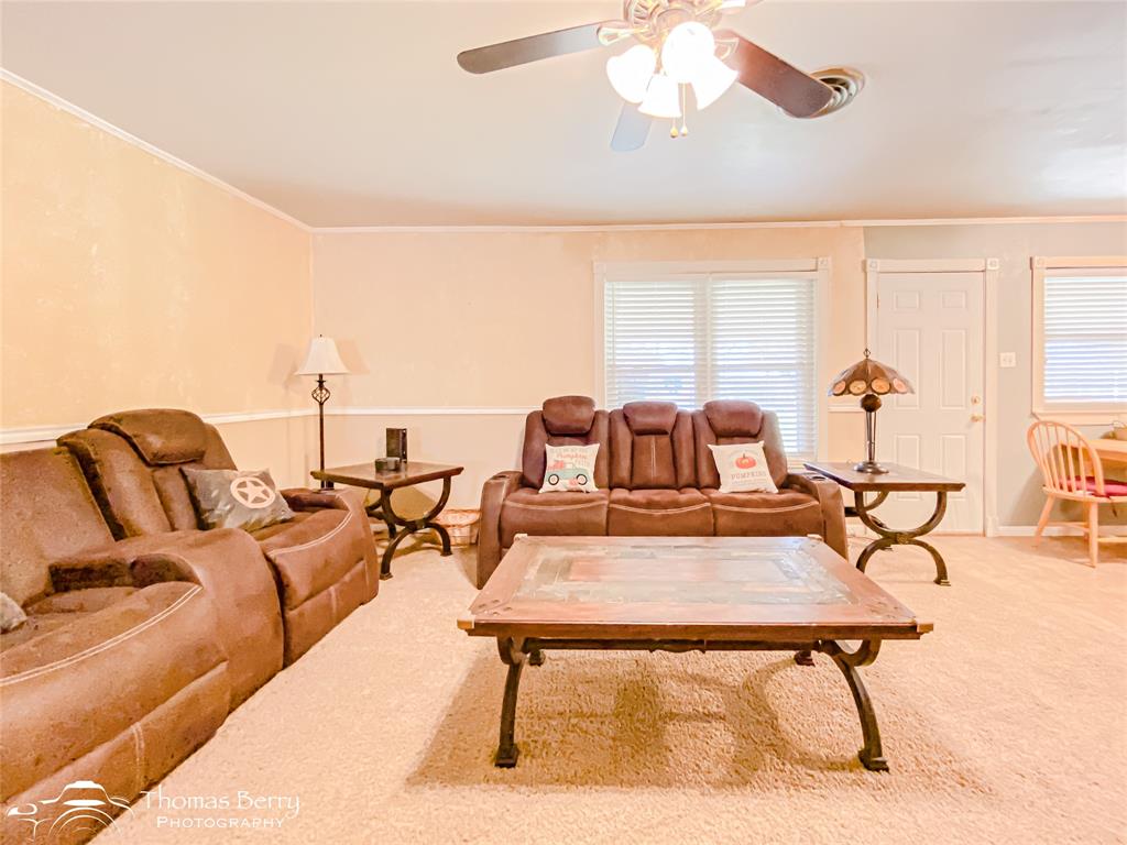 1104 Hickory Street Roscoe, TX 79545 - Photo 6 of 22 Living room featuring ornamental molding, carpet, and ceiling fan