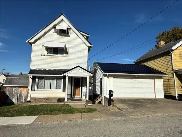 a front view of a house with a garage