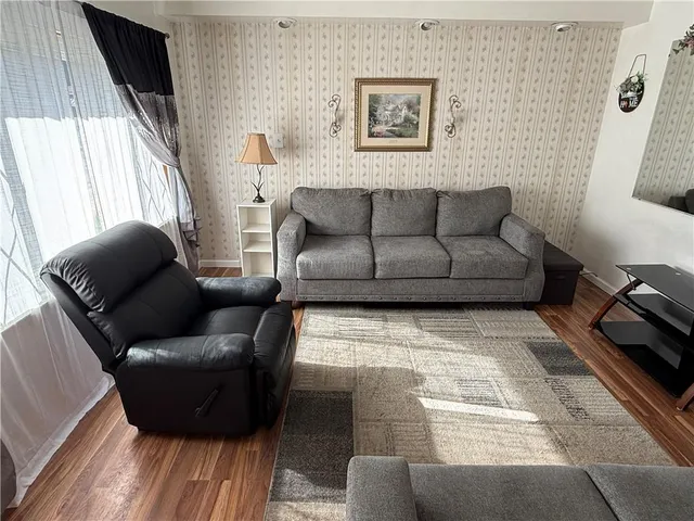 a living room with furniture and a rug