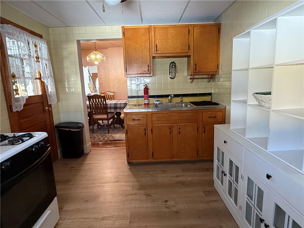 512 Watson Street Vandergrift, PA 15690 - Photo 18 of 35 a kitchen with stainless steel appliances granite countertop a stove a sink and a microwave
