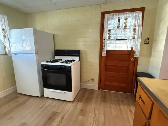 a close view of a utility room with mirror and shower