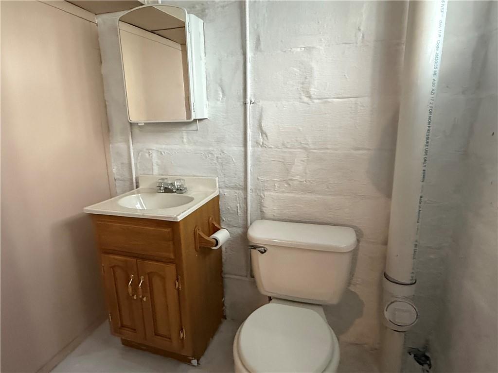 512 Watson Street Vandergrift, PA 15690 - Photo 33 of 35 a bathroom with a toilet sink and mirror