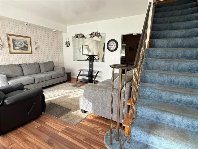 a view of a livingroom with furniture and a window
