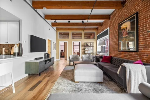 a living room with furniture and a large window