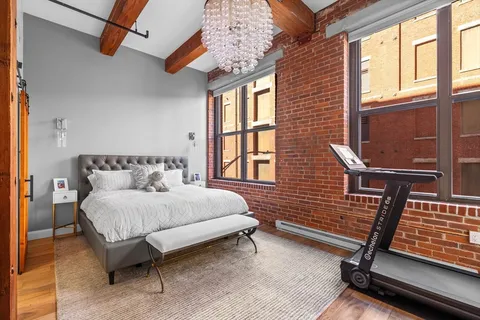 a view of a brick house with wooden floor and windows