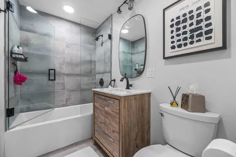 a bathroom with a toilet a sink and mirror