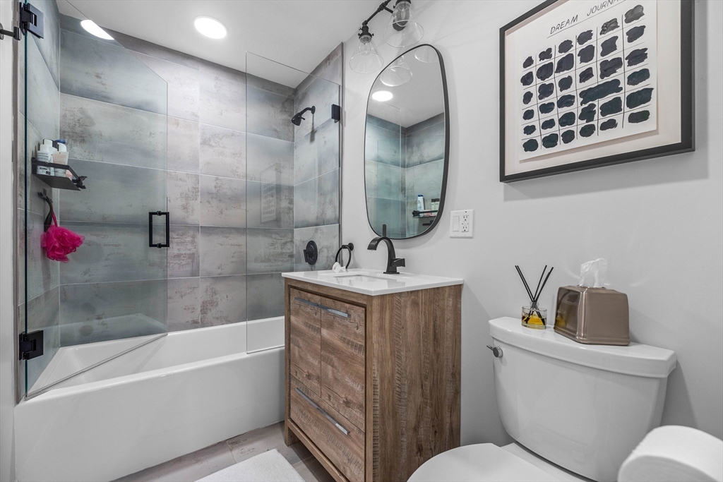 15 Sleeper Street, Unit 206 Boston, MA 02210 - Photo 16 of 21 a bathroom with a toilet sink and mirror