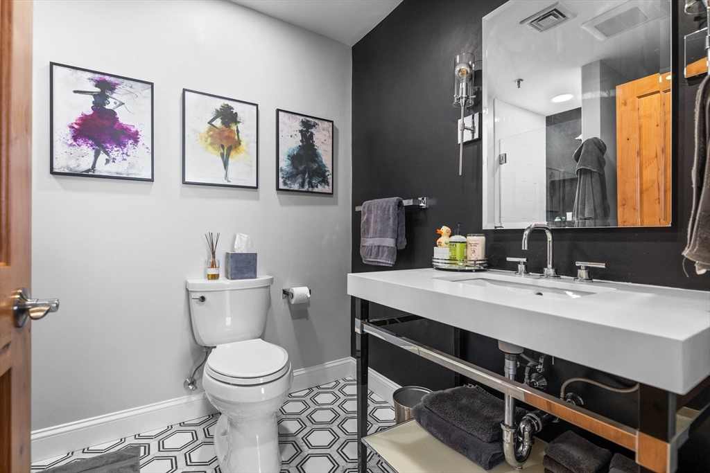 15 Sleeper Street, Unit 206 Boston, MA 02210 - Photo 18 of 21 a bathroom with a toilet a sink and mirror