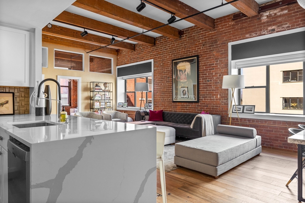15 Sleeper Street, Unit 206 Boston, MA 02210 - Photo 2 of 21 a living room with furniture and windows